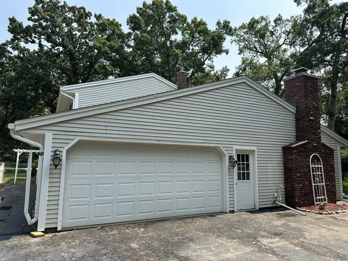 Garage side of the Delafield home after washing, siding and trim back to color