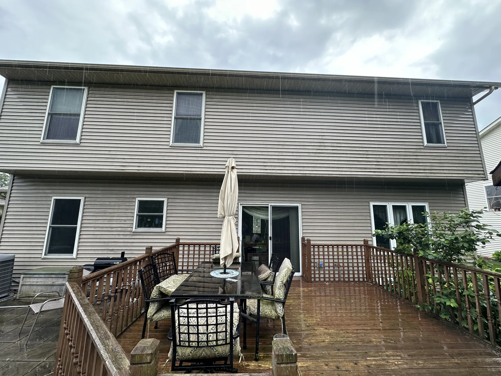 Rear elevation of the Waukesha home before soft washing, growth dulling the whole wall